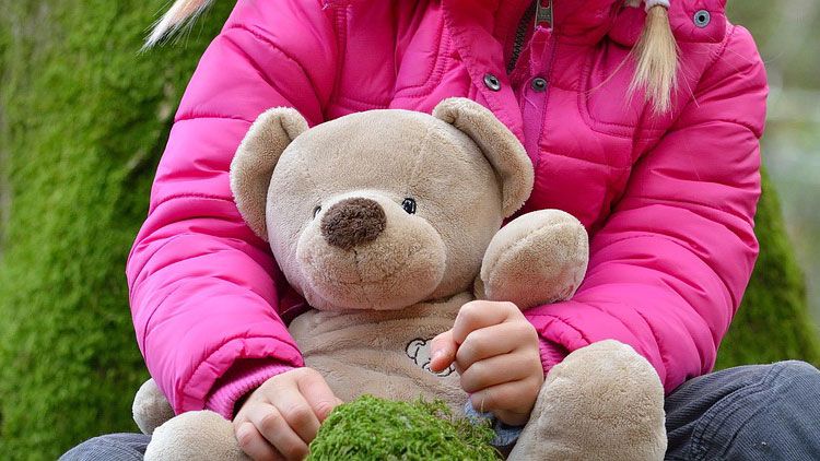 Child and toy bear